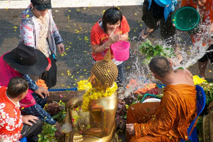 Receiving a blessing with scented water from a monk