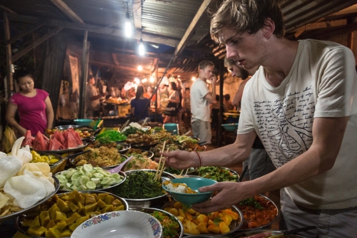 Trying local Lao food is also a great way to save money when traveling to Laos with family