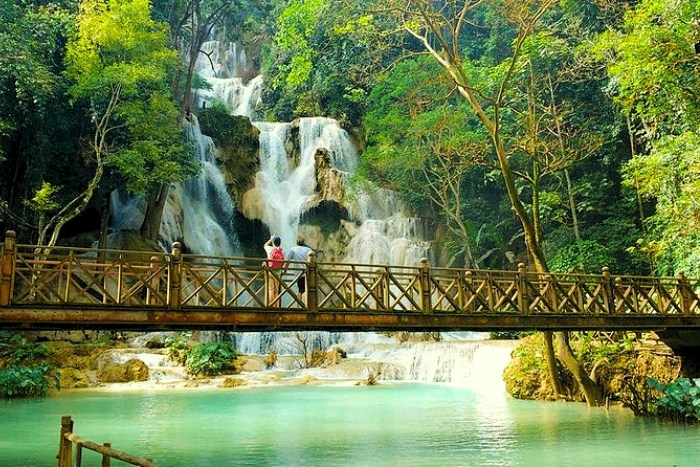 Turquoise waters of the Kuang Si waterfalls, a symbol of a sunny trip to Laos