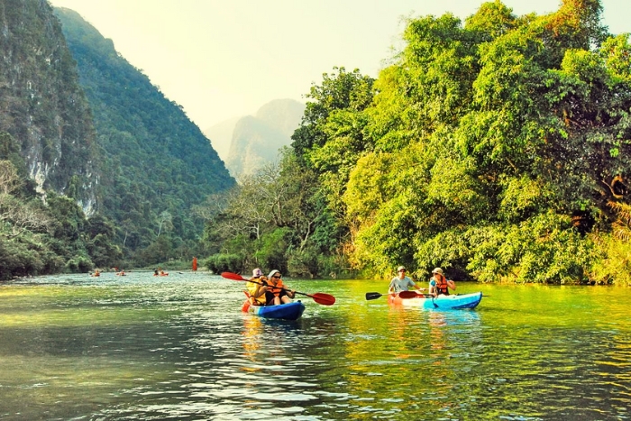 Kayaking down the Nam Song River in Vang Vieng under the Lao sun