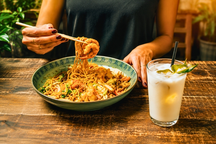 Enjoying Phuket Hokkien Mee, a local culinary specialty