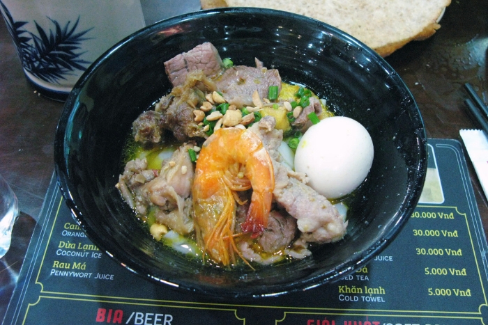 A bowl of Mi Quang with shrimp and egg