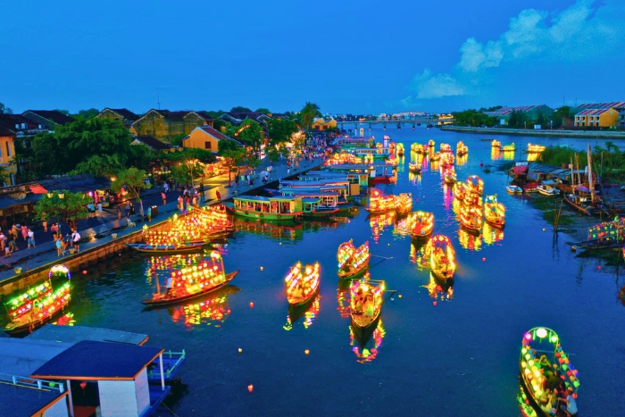 Evening lights shimmer across the Thu Bon River