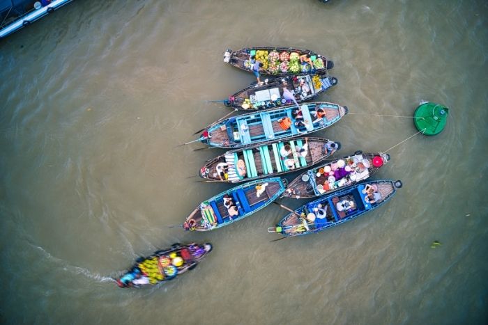 Watching the sunrise from a boat at the Cai Rang floating market is truly a memorable travel experience