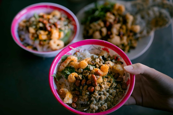 Warm flavours of cơm hến on a rainy day in Hue