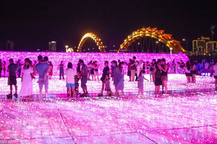An illuminated space on the west bank of the Hàn River, near the Dragon Bridge – Da Nang