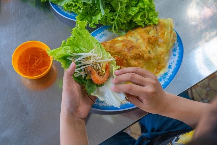 Vietnamese crispy banh xeo during a Saigon street food tour