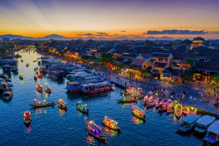 Lantern-lit boats drifting peacefully on the Hoai River