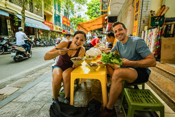 Tasting Vietnamese street food in summer during a budget trip
